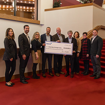 United Way associates pictured with Pete McPartland and the 2023 donation check